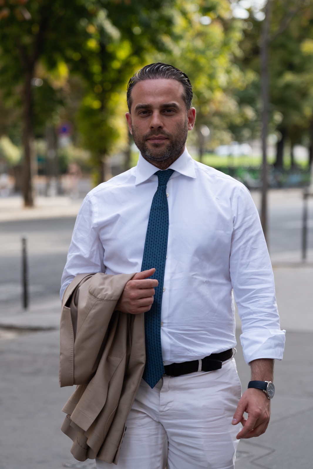 Wadim Rosenstein outdoors in a white shirt and blue tie during the 2026 FIDE presidential campaign